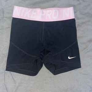 Black Nike pros with pink waistband